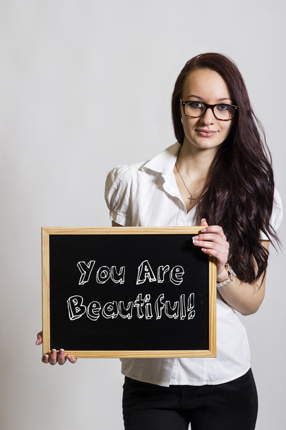 You Are Beautiful! - Young businesswoman holding chalkboard - Φωτογραφία, εικόνα