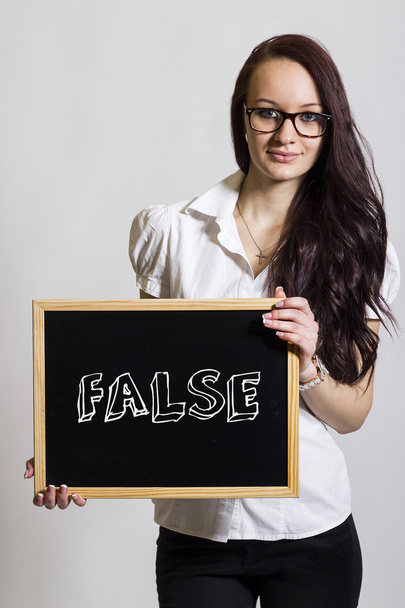 FALSE - Jovem empresária segurando quadro-negro
 - Foto, Imagem