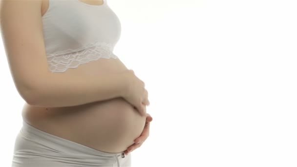 Pregnant woman stroking belly - Footage, Video