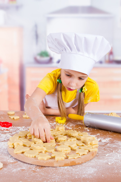the girl lays on the Board from dough cookies - Photo, Image