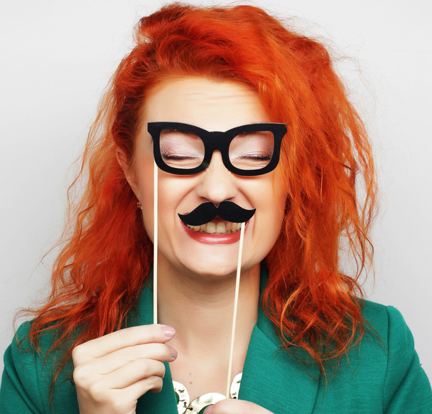 young woman holding mustache  on a stick. - Φωτογραφία, εικόνα