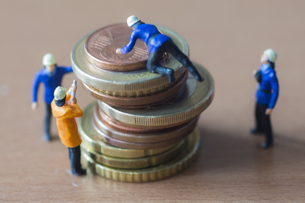 Mini trabajadores y monedas
 - Foto, imagen