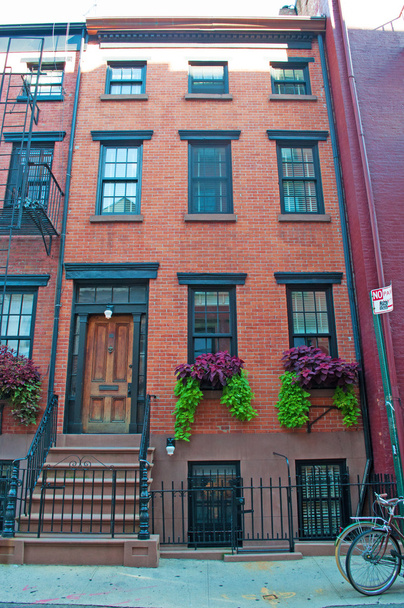 New York City: a typical red townhouse in the streets of the Greenwich Village, referred to by locals as simply The Village, one of the most iconic neighborhoods of the city, west side Lower Manhattan - Photo, Image
