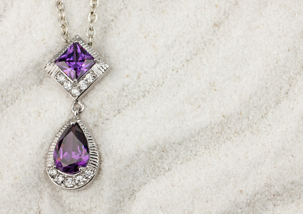 jewelry pendant with diamonds on white sand background, with cop - Φωτογραφία, εικόνα