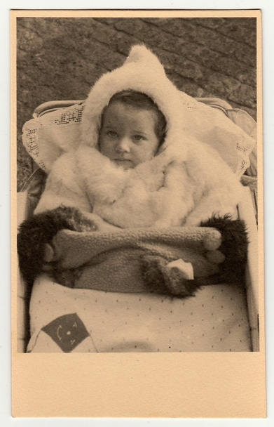Foto vintage mostra bebê menina em um carrinho de bebê, por volta de 1940
. - Foto, Imagem