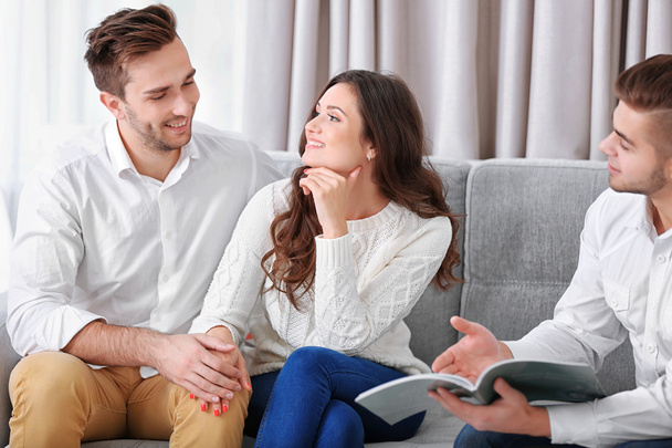 Estate agent presenting project to couple - Photo, image