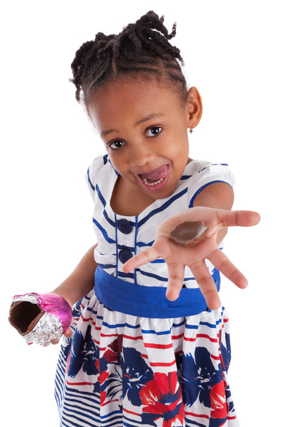 Little african american girl eating chocolate easter egg - Fotoğraf, Görsel
