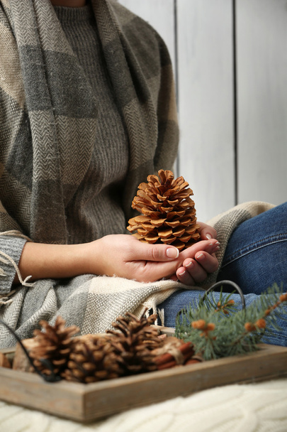 Woman holding pine cone  - Фото, зображення
