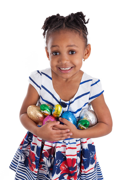 Little african american girl holding chocolate easter eggs - Foto, Imagen