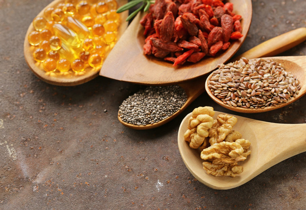 Super food - goji berries, chia seeds, flax seeds, walnuts and omega-3 capsules - Photo, Image