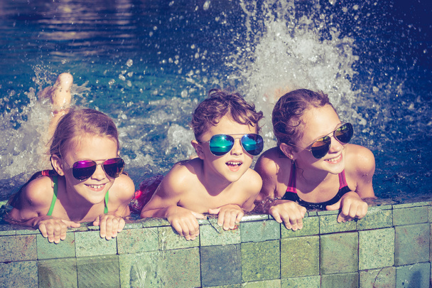 happy children  playing on the swimming pool at the day time - Foto, Bild
