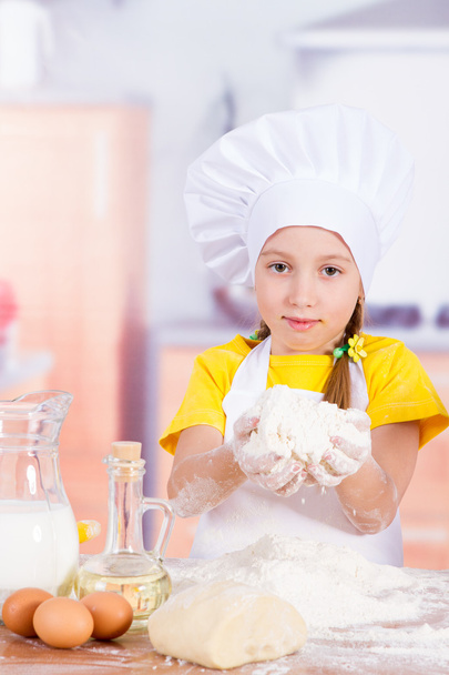 Girl chef holding a pile of flour, eggs - Fotoğraf, Görsel