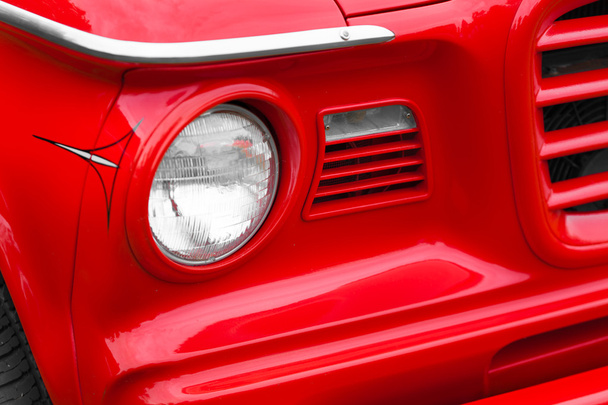 Egy piros vintage autó bal fényszóró - Fotó, kép