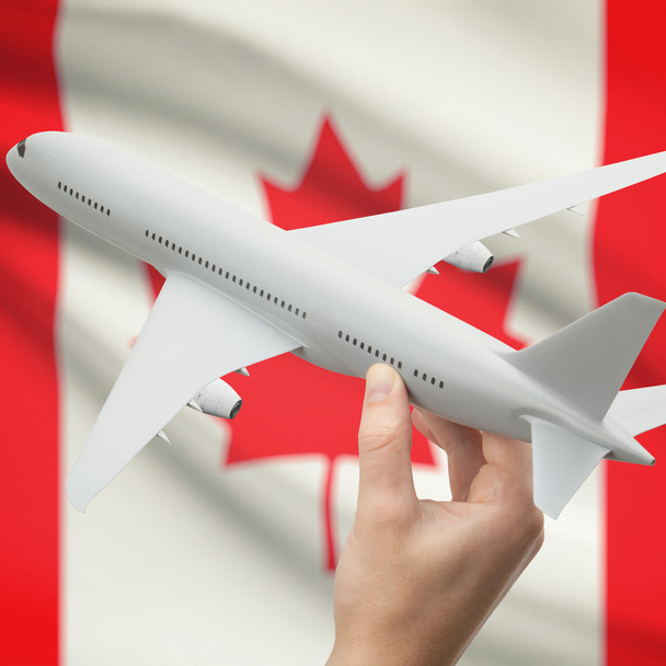 Airplane in hand with flag on background series - Canada - Foto, afbeelding