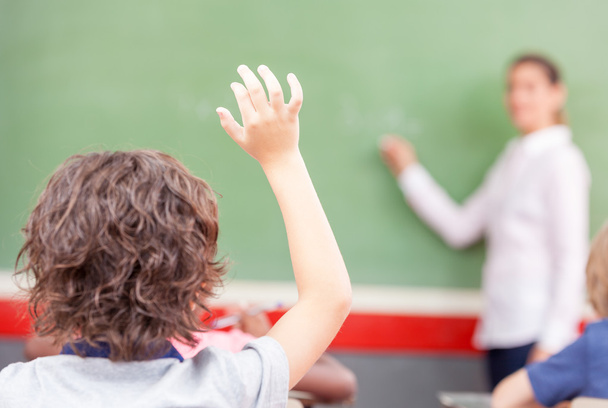 Raising hand at class lesson, primary school scene. Success and  - Фото, изображение