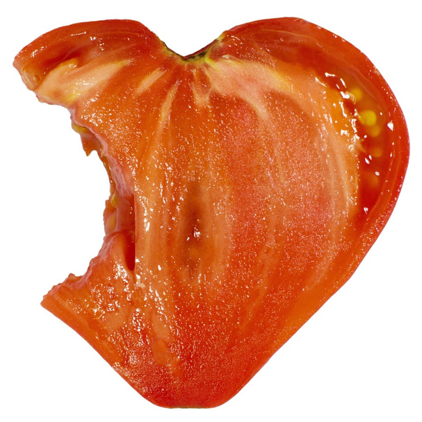 bitten cut of heart shape tomato - Foto, Imagem