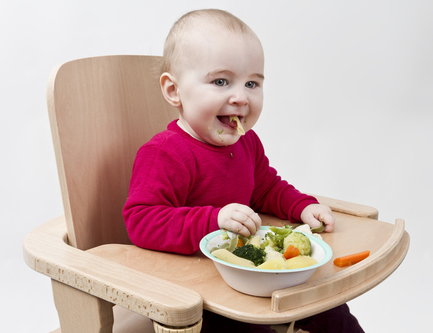 Young child eating in high chair - Photo, Image