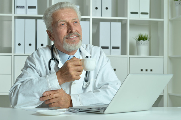 Elderly doctor with  laptop - Photo, Image