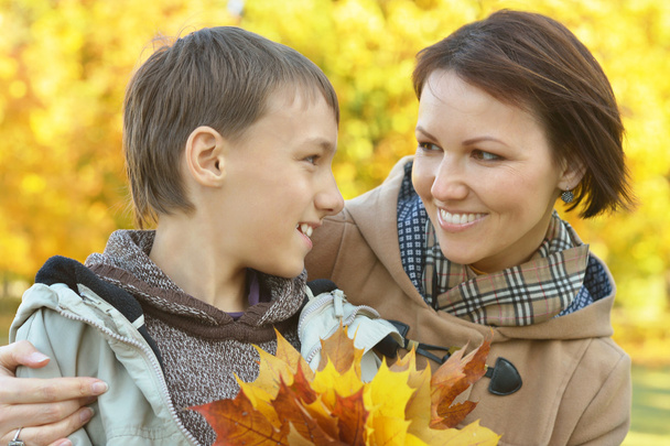 Mother with boy in autumn park - Photo, Image