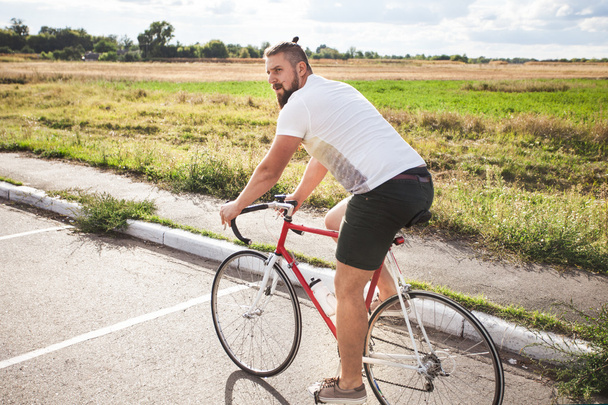Jong gebaard hipster fiets rijden  - Foto, afbeelding