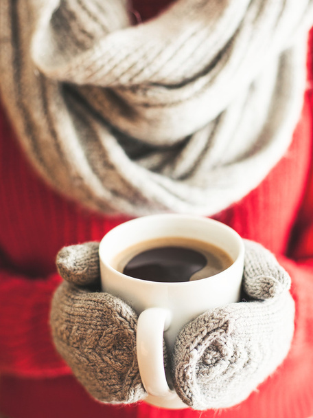  Woman hands in teal gloves holding a mug with hot coffee. - Photo, Image