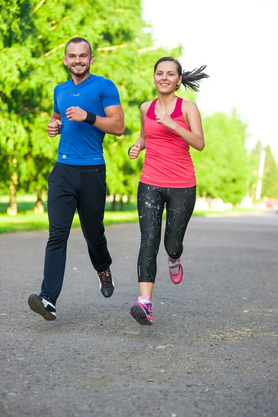 Runners training outdoors working out. City running couple jogging outside. - Foto, Imagem