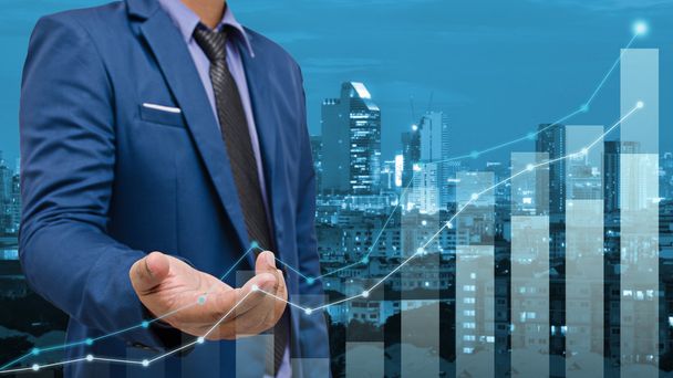 business man touch visual graph screen with cityscape background - Photo, Image