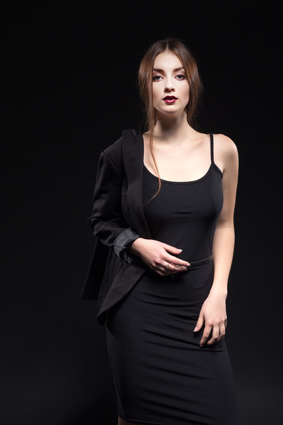 beautiful woman in sexy evening dress against dark background - Fotó, kép