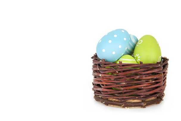 Uova di Pasqua in cesto su sfondo bianco - Buona Pasqua
 - Foto, immagini