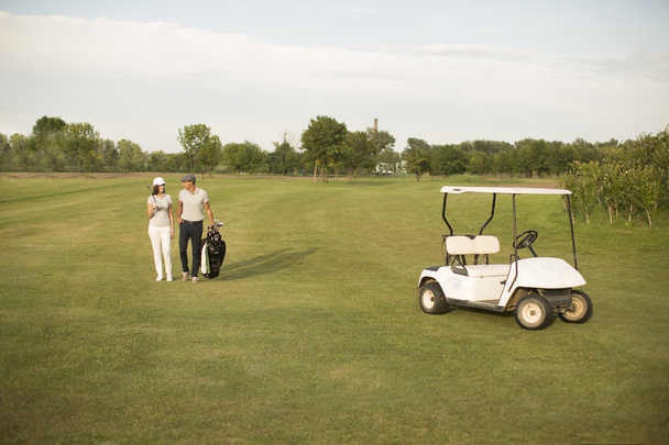 Пара в кошику для гольфу
 - Фото, зображення