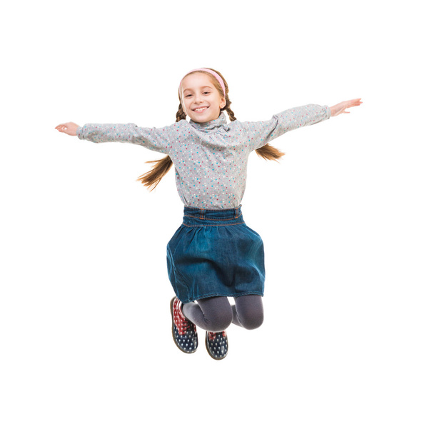 photo of joyful little girl jumping - Foto, Imagem
