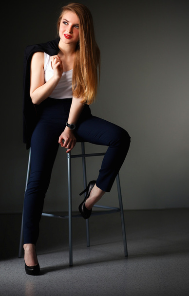 Young woman sitting on a chair - Fotoğraf, Görsel