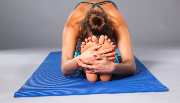 Portrait of sport girl doing yoga stretching exercise - Fotografie, Obrázek