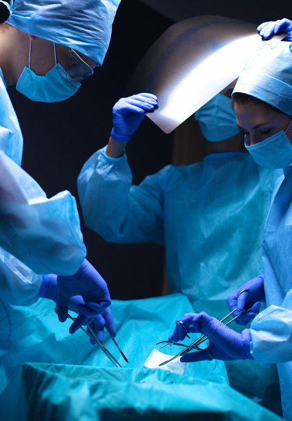 Team surgeon at work in operating room. - Фото, изображение