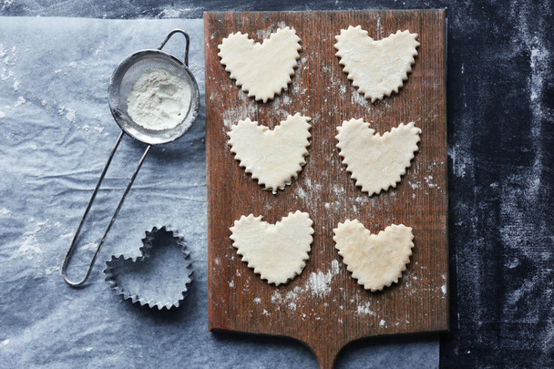 Uncooked heart shaped biscuits on a table - Photo, Image