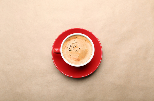 Cup of coffee on beige background, top view - Foto, Imagem