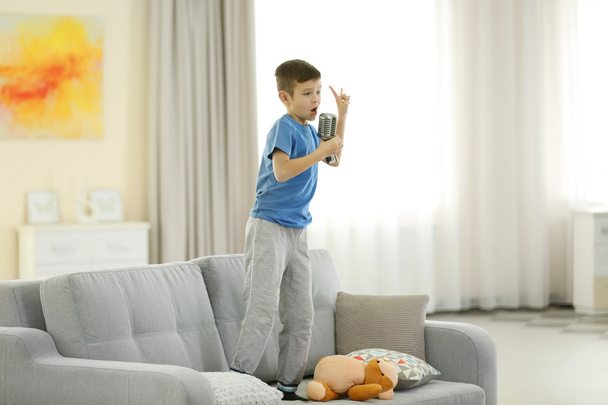 Little boy singing with microphone  - 写真・画像
