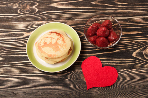 sweet pancakes with strawberry, handmade heart - 写真・画像