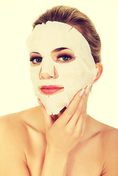 Young woman with facial mask - Photo, image