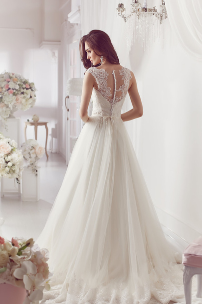 The beautiful woman posing in a wedding dress - Zdjęcie, obraz