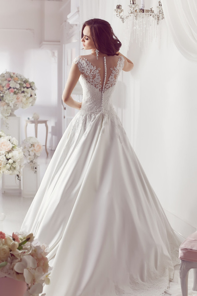 The beautiful woman posing in a wedding dress - Photo, image