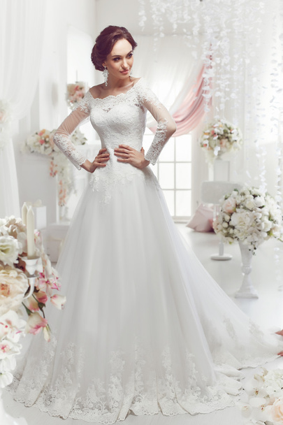 The beautiful woman posing in a wedding dress - Фото, зображення