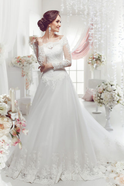 The beautiful woman posing in a wedding dress - Fotó, kép
