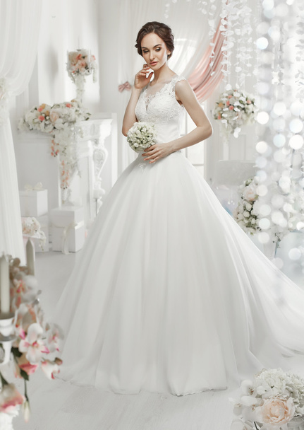 The beautiful woman posing in a wedding dress - Foto, Imagem