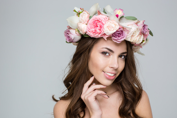 Woman with wreath from flowers on head looking at camera - Foto, Imagen