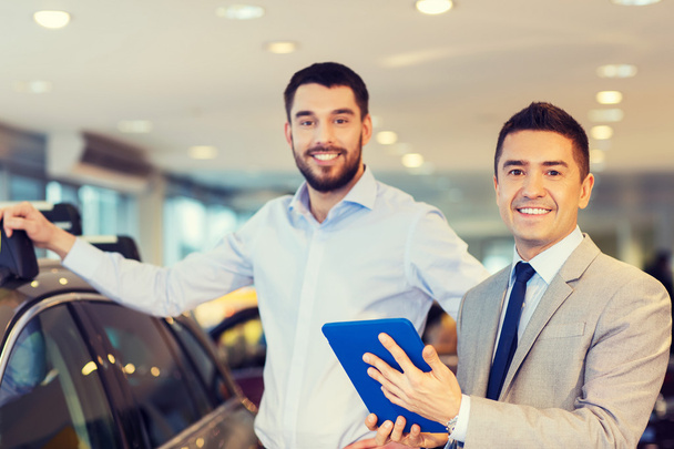 happy man with car dealer in auto show or salon - Photo, Image