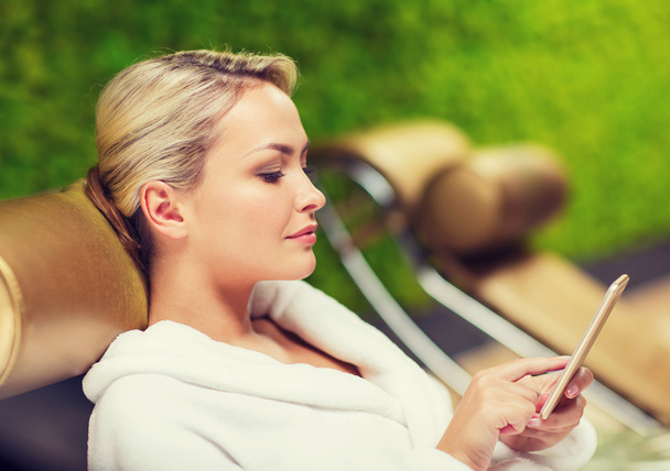 beautiful young woman with smartphone at spa - Photo, image