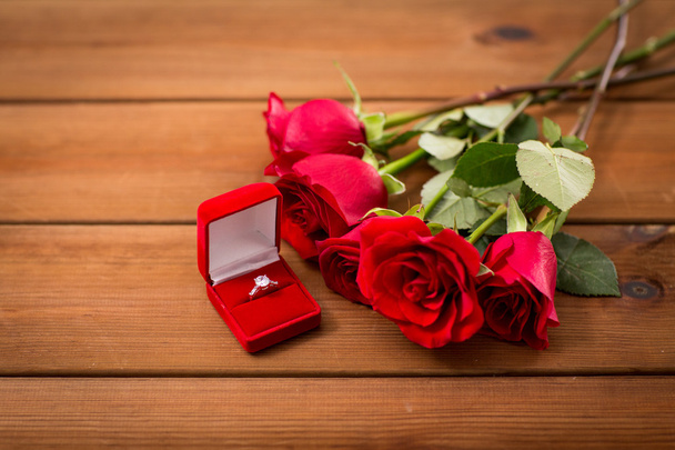 close up of diamond engagement ring and red roses - Photo, image