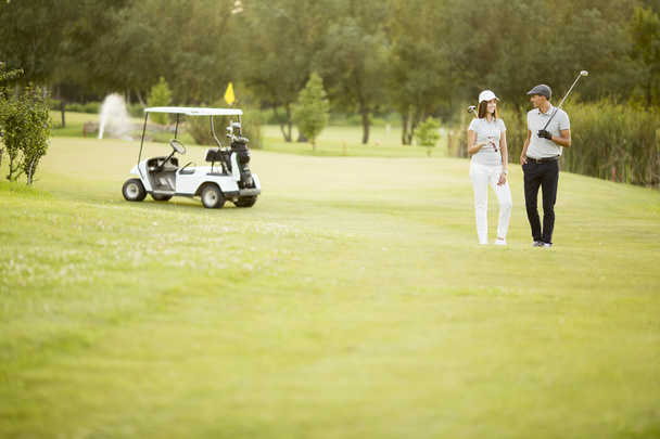 Couple at golf cart - 写真・画像