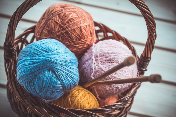 Background of basket with colorful balls of yarn with knitting needles - Φωτογραφία, εικόνα
